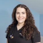 Female Veterinarian with long dark curly hair